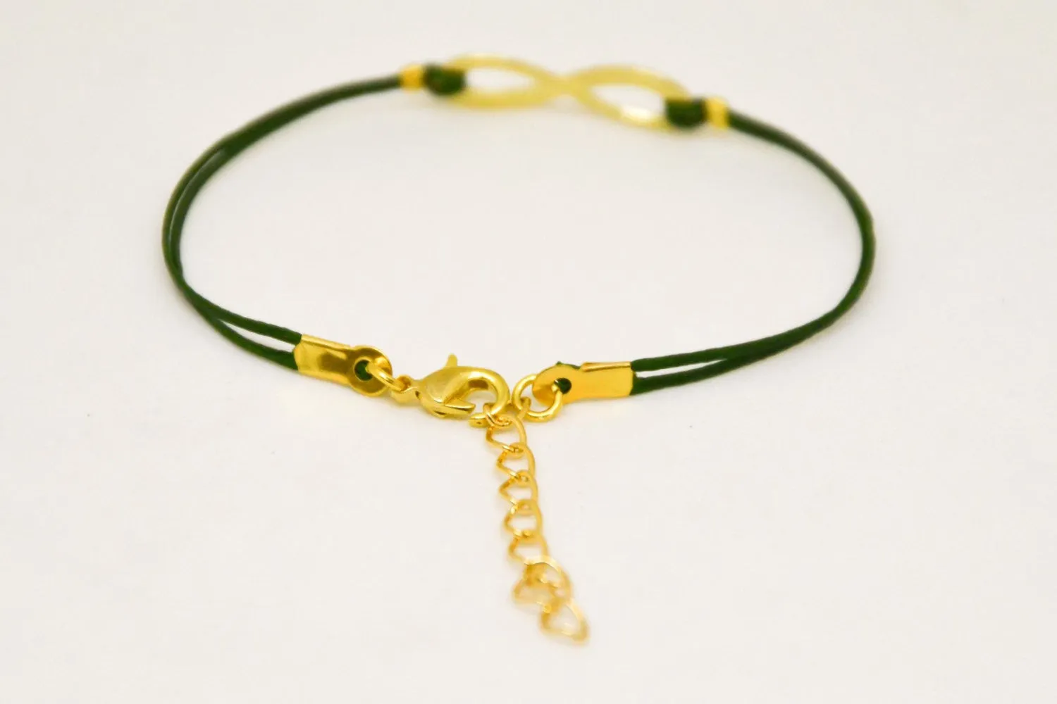 Gold infinity bracelet for women, green cord, yoga jewelry