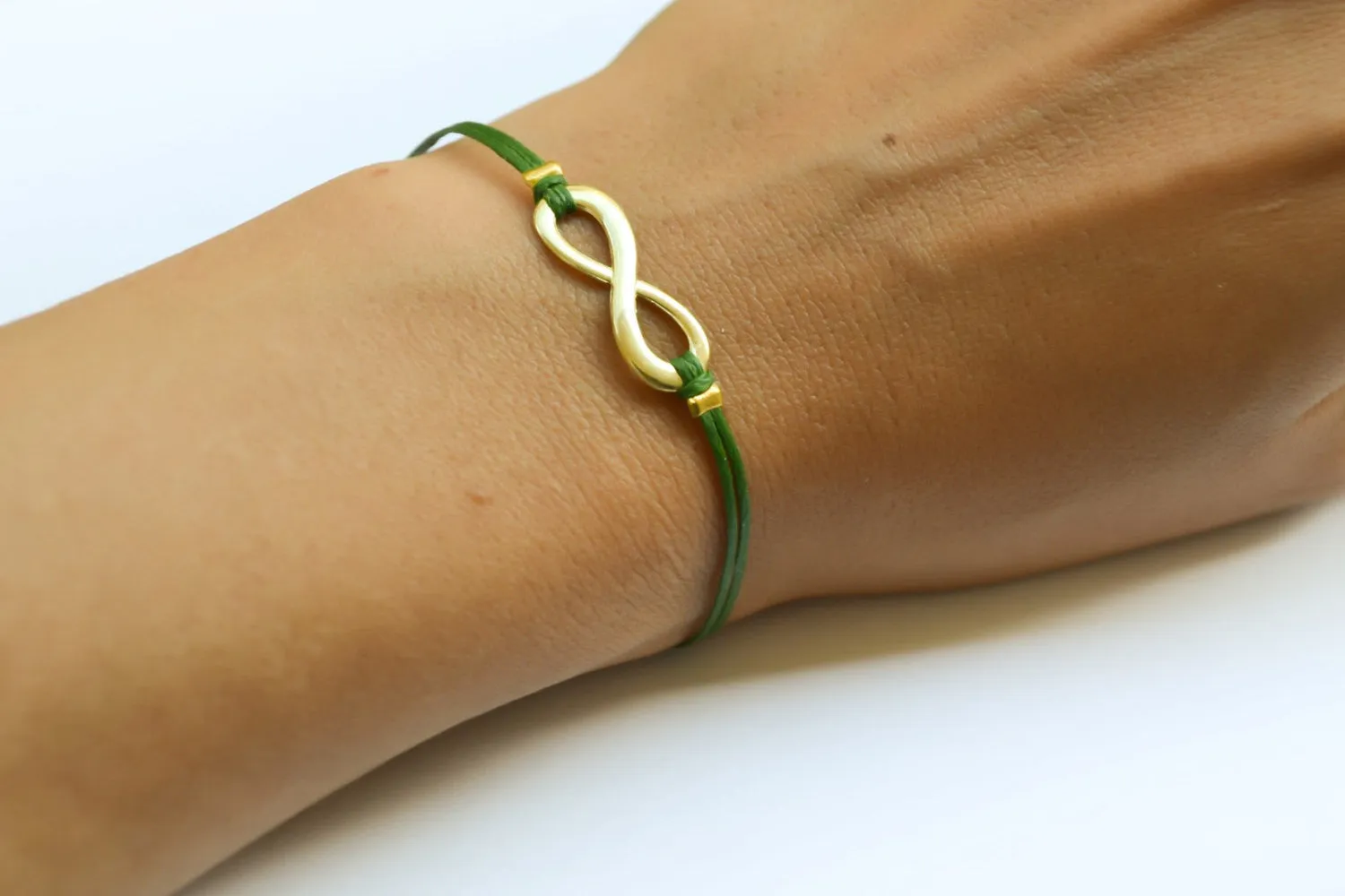 Gold infinity bracelet for women, green cord, yoga jewelry