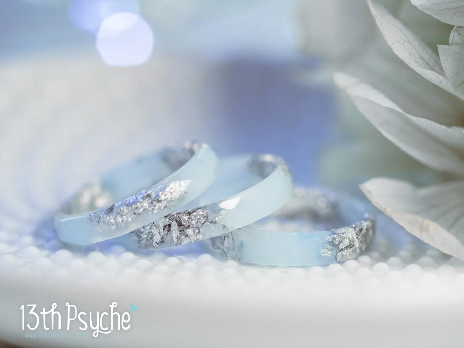 Pastel blue faceted resin ring with silver flakes