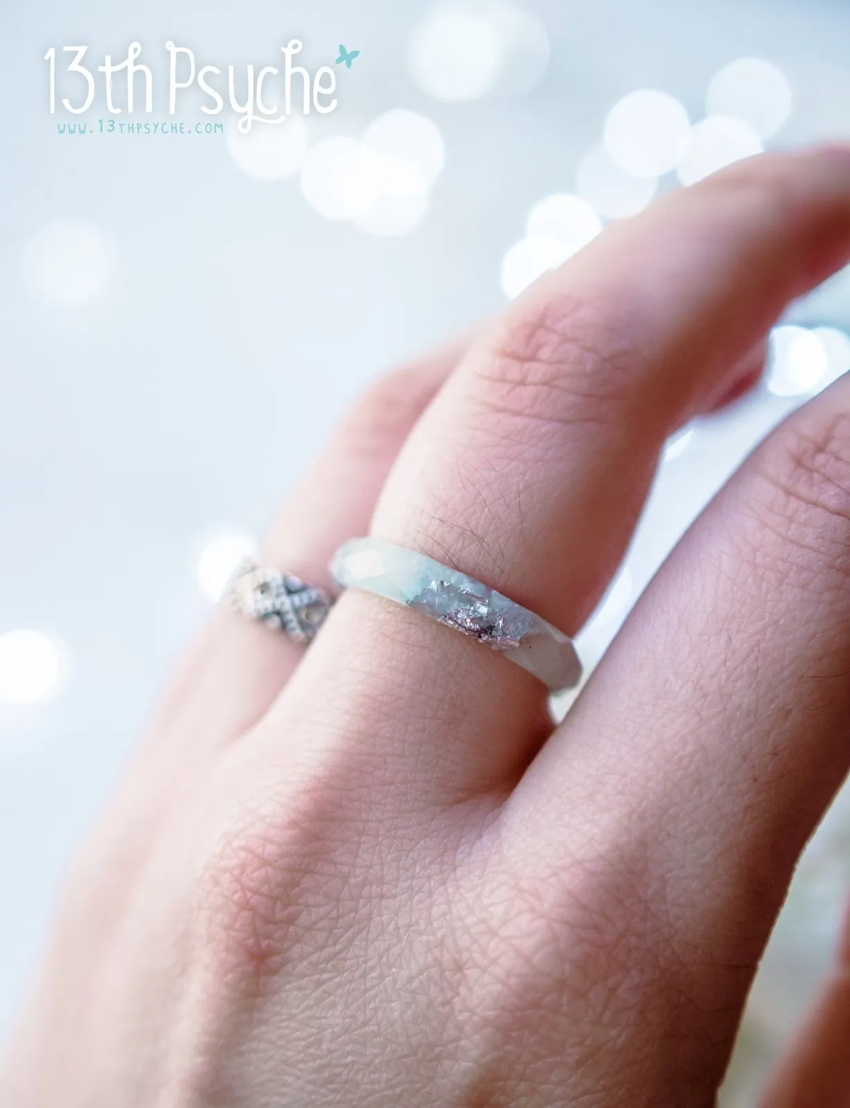 Pastel blue faceted resin ring with silver flakes